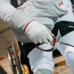 Close-up of a wheelchair fencer gripping a sabre, showcasing focus and determination in sport